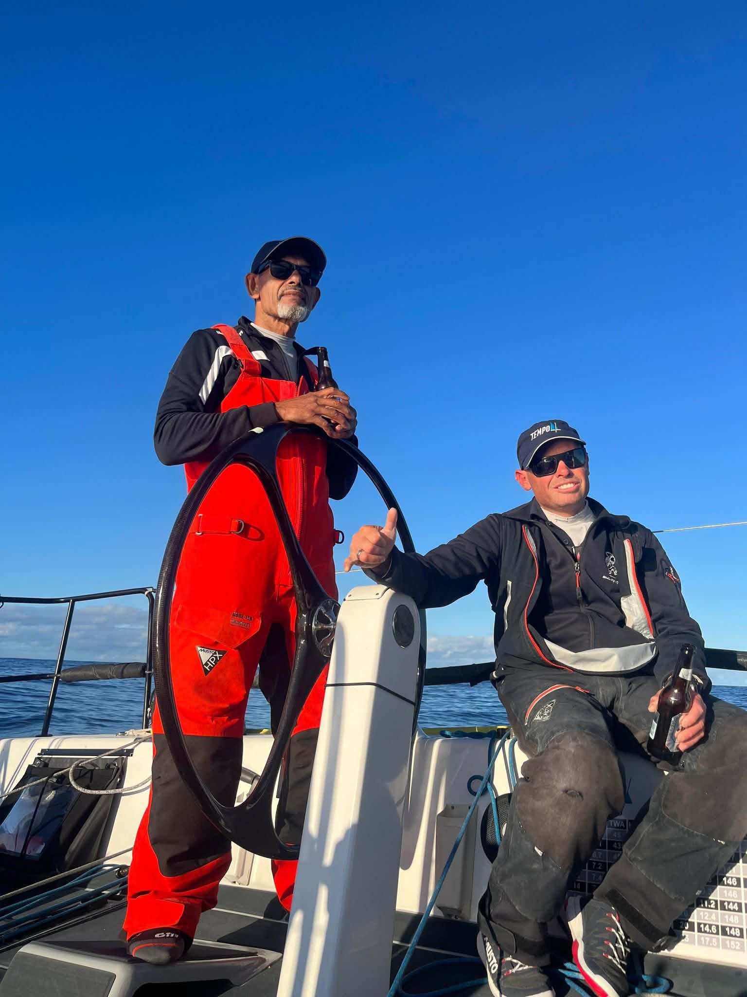 Offshore sailors at the helm during a yacht passage