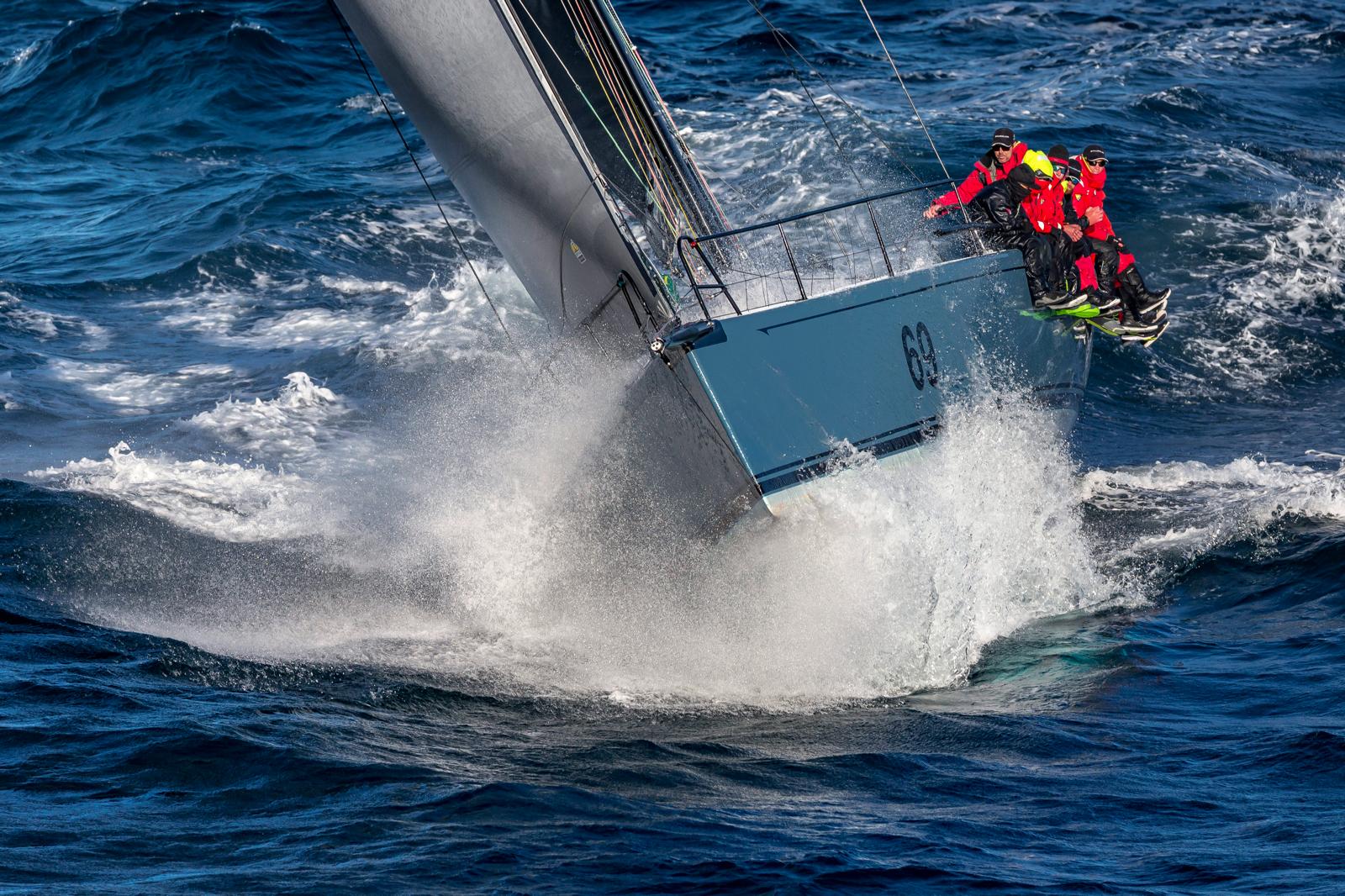 Offshore racing yacht driving through heavy seas