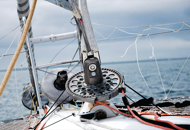 Sailboat furling and line-handling hardware mounted on a mast